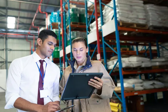 Warehouse Staffs Discussing Digital Tablet Warehouse - American Production and Inventory Control Society Certified study guide