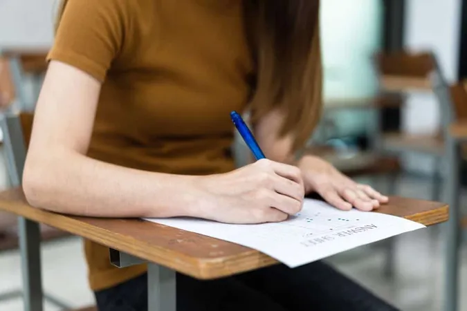 Close Up Young Female University Students Concentrate Doing Examination Classroom Girl Student Writes Answer Examinations Answer Sheet Classroom 3 X - CELPIP study guide