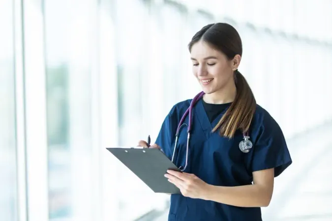 Smiling Young Female Doctor Holding Clipboard Hospital 1 X - Certified Health Service Administrator study guide