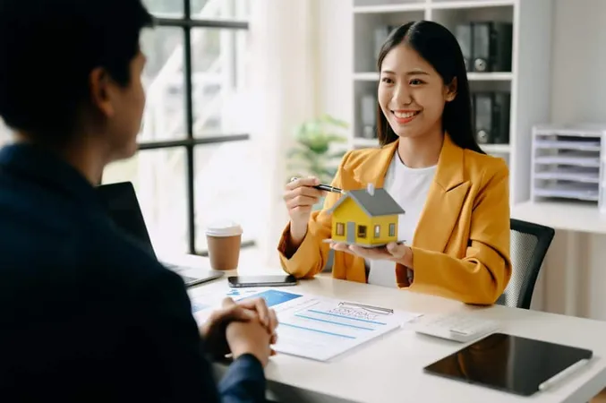 Asian Real Estate Broker Agent Presenting Consult Customer Decision Making Sign Insurance Form Agreement Home Model Concerning Mortgage Loan Offer Office X - Certified Mortgage Advisor study guide