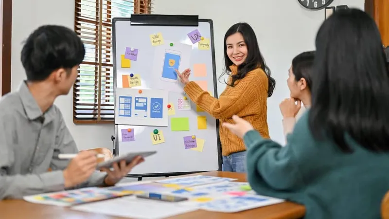 Professional Asian Female Graphic Designer Presenting Her New Prototype Her Team Ux Ui Startup X - Certified Marketing Professional study guide