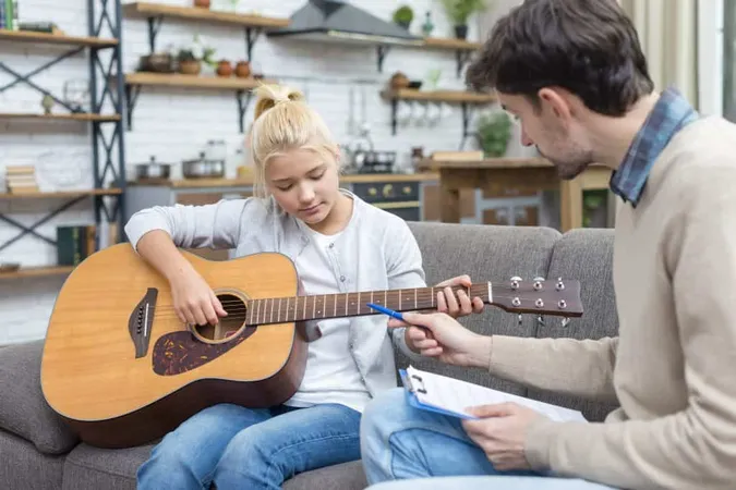 Young Student Learning How Hold Guitar X - Certified Music Therapist study guide