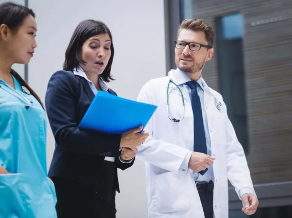 Doctors Nurse Interacting While Walking X - Certified Physician Executive study guide