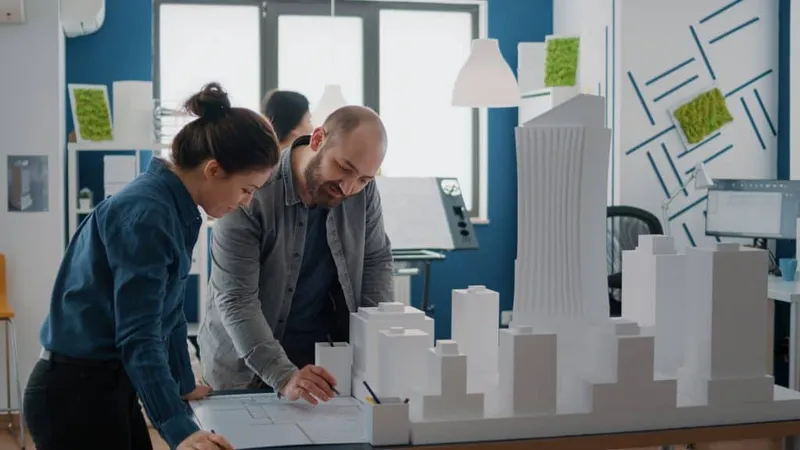 Team Colleagues Using Building Model Inspiration Design Construction Layout Man Woman Working With Maquette Plan Blueprints Urban Structure Architectural Project X - Certified Risk Architect study guide