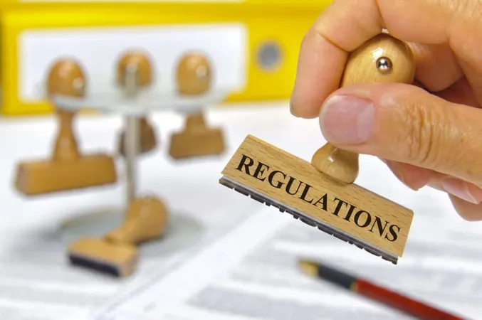 Cropped Hand Holding Rubber Stamp With Regulations Text Table X - Certified Regulatory Affairs Professional study guide