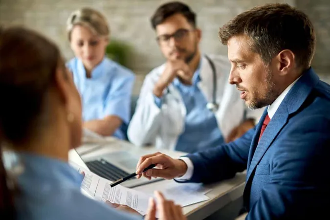 Mid Adult Businessman Healthcare Workers Analyzing Documents Meeting Office X - Certified Regulatory Affairs Professional study guide