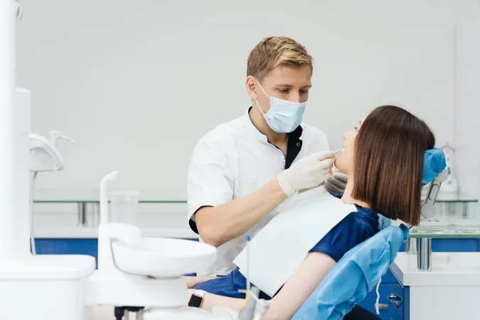Close Up Portrait Beautiful Young Lady Sitting Dental Chair While Stomatologist Hands Sterile Gloves Holding Tooth Samples X - Doctor of Medicine in Dentistry study guide