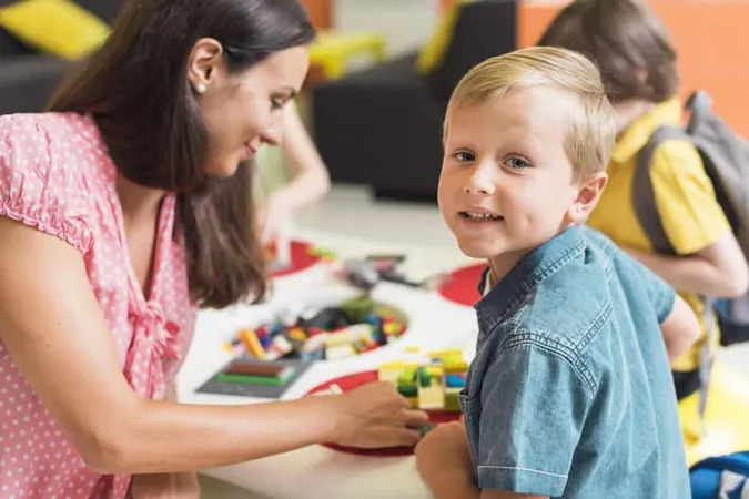 Teacher Playing With Kindergarten Kid X - Early Childhood Education Certificate study guide