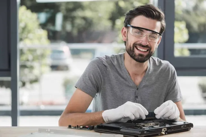 Portrait Happy Young Male Technician Repairing Computer X - HP Certified Professional study guide