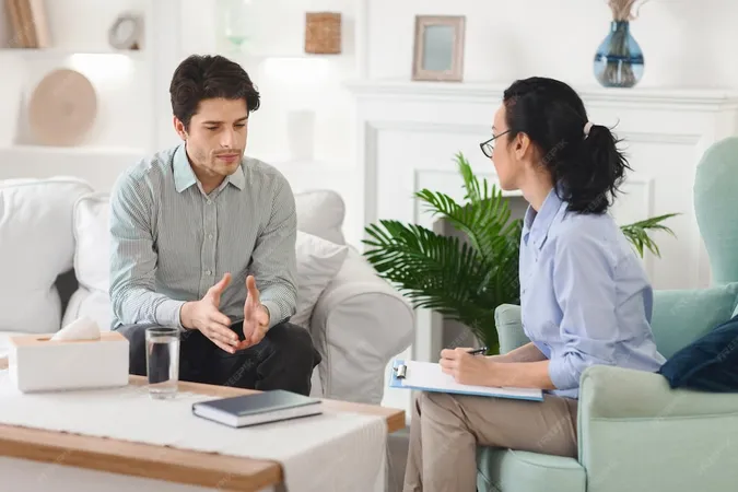 Man Is Engaged Counseling Session With Woman Therapist Comfortable Living Room They - Certified Health Service Psychologist study guide
