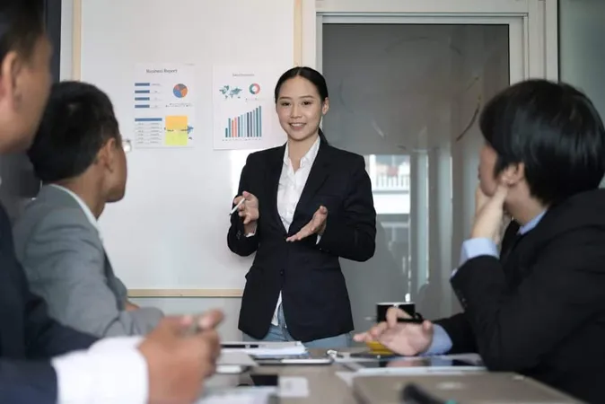 Businesswoman Present Financial Plan Report Co Worker Team Woman Leader Discuss Data X - Leadership and Performance Coaching Certification study guide