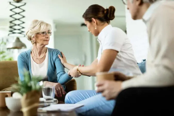 Female Nurse Communicating With Senior Woman While Being Home Visit Focus Is Senior Woman X - Licensed Social Worker Associate Certification study guide
