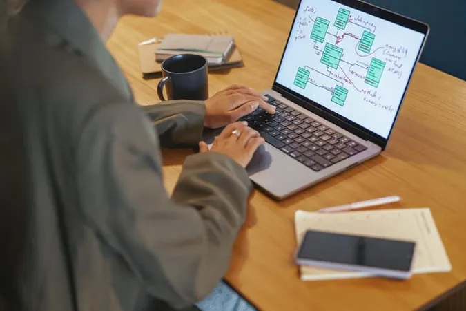 Person Sitting Desk Using Laptop Computer - Microsoft 365 Fundamentals Certification study guide