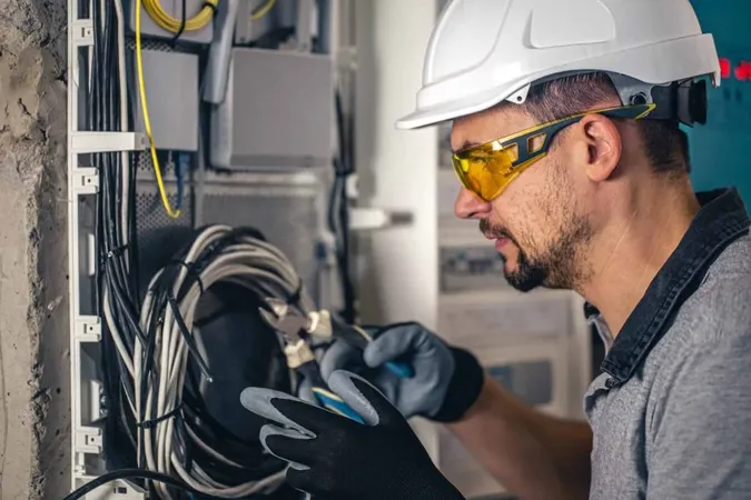 Man Electrical Technician Working Switchboard With Fuses 1 X - National Electrical Contractors Association study guide