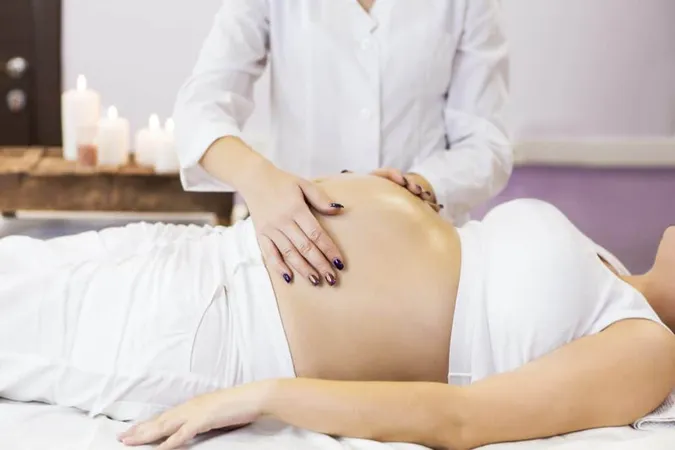 Midsection Woman Lying Bed X - Prenatal Massage Certification study guide