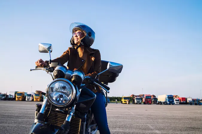 Female Motorcyclist Leather Jacket Helmet Sitting Retro Motorbike Smiling - Riding Theory Test study guide