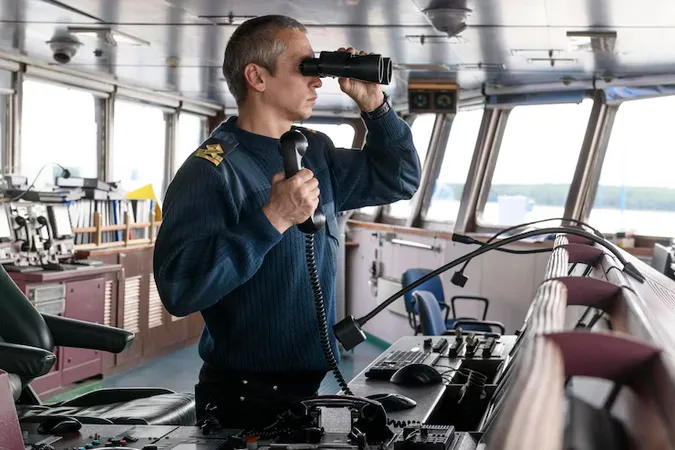 Deck Officer With Binoculars Navigational Bridge Seaman Board Vessel Commercial Shipping - Vessel Traffic Services Operator Exam study guide